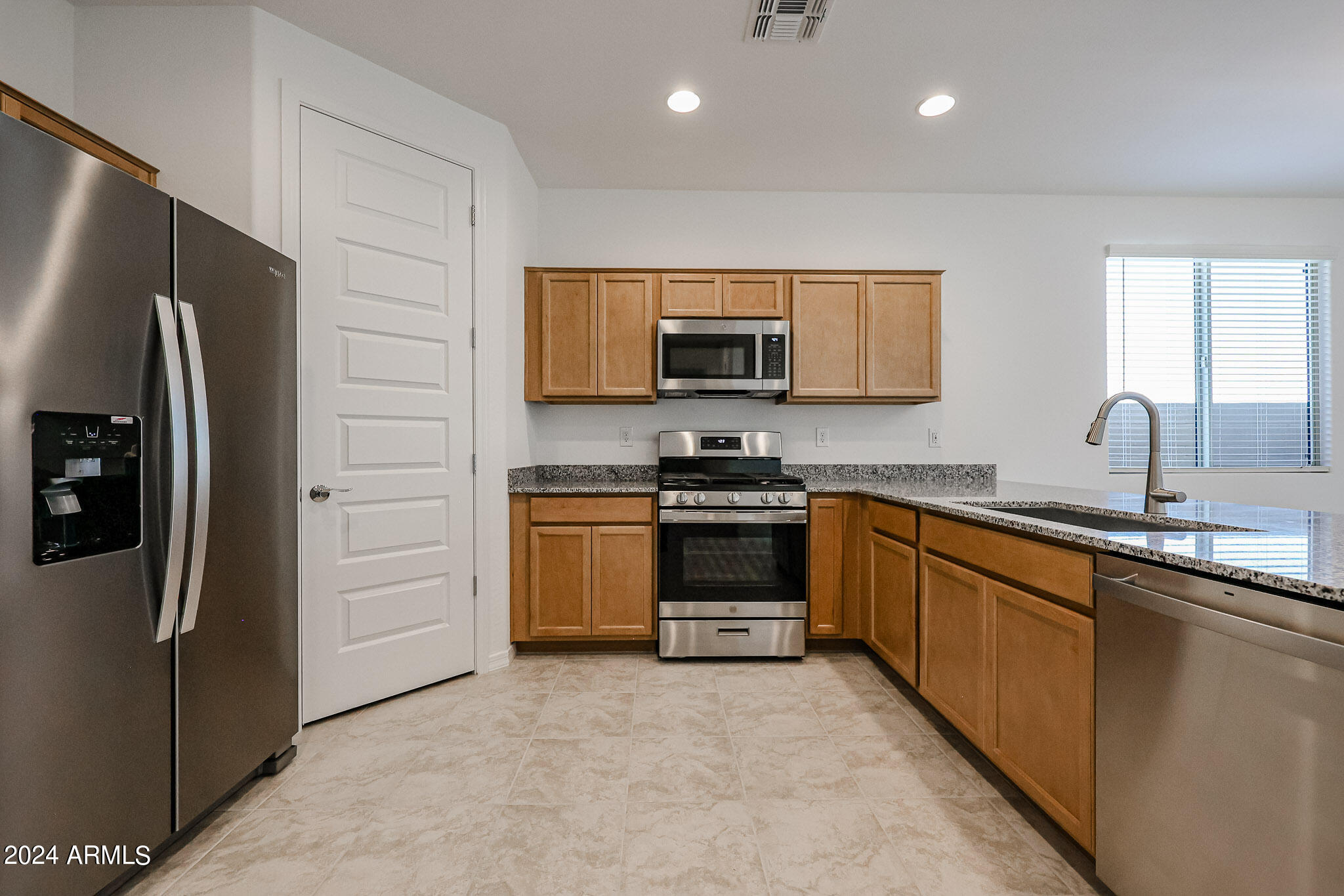 8907 West Colter Street Glendale, AZ 85305 - Photo 5 of 44 a kitchen with stainless steel appliances a refrigerator sink and microwave