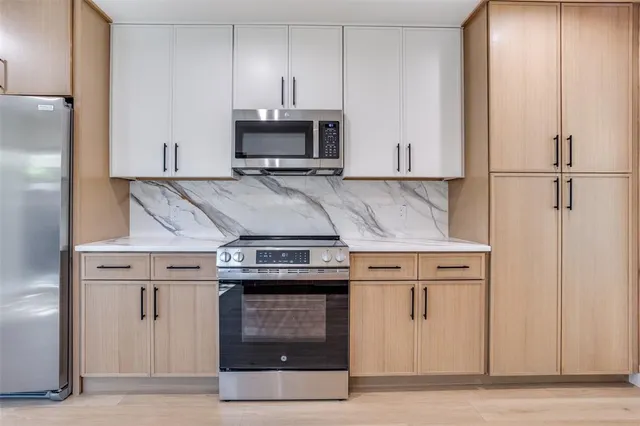 a stove top oven sitting inside of a kitchen