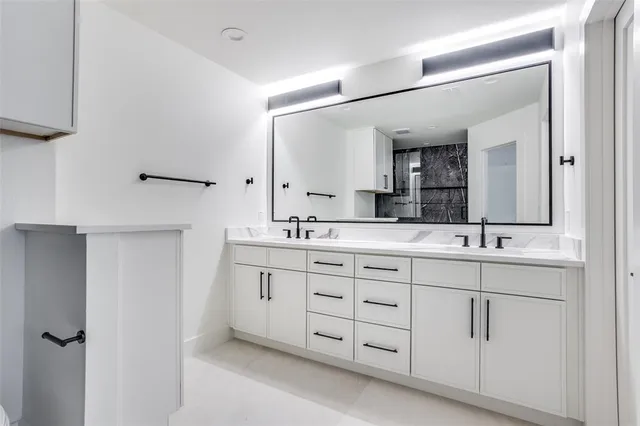 a bathroom with a granite countertop sink a toilet and shower