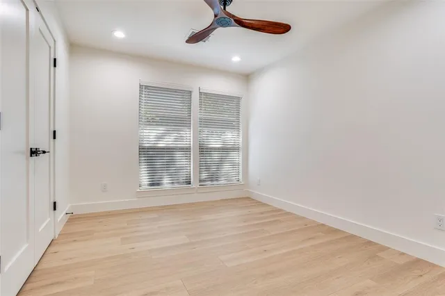 a view of an empty room with a ceiling fan
