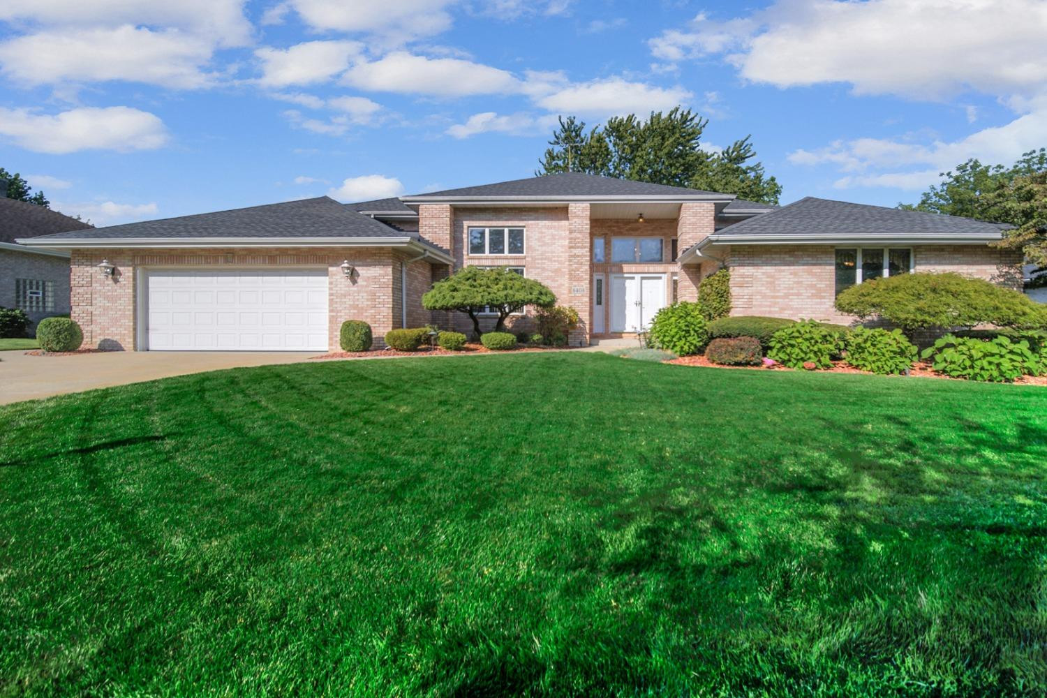 a front view of a house with a yard and garage