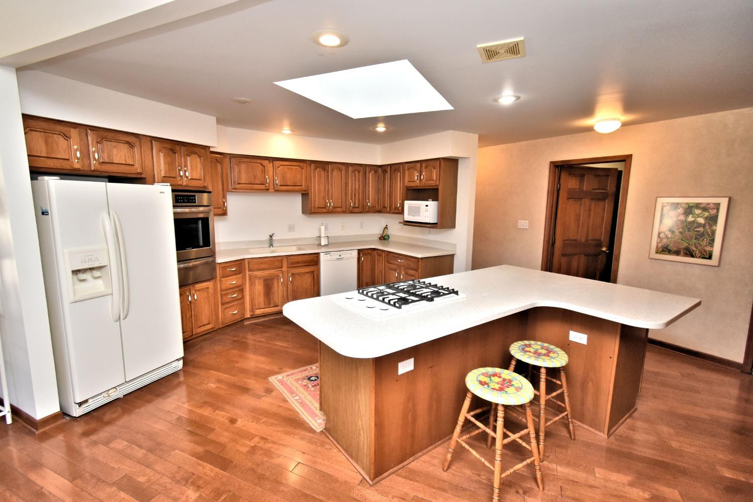 8408 Castle Drive Munster, IN 46321 - Photo 11 of 28 a kitchen with stainless steel appliances kitchen island granite countertop a sink refrigerator and cabinets