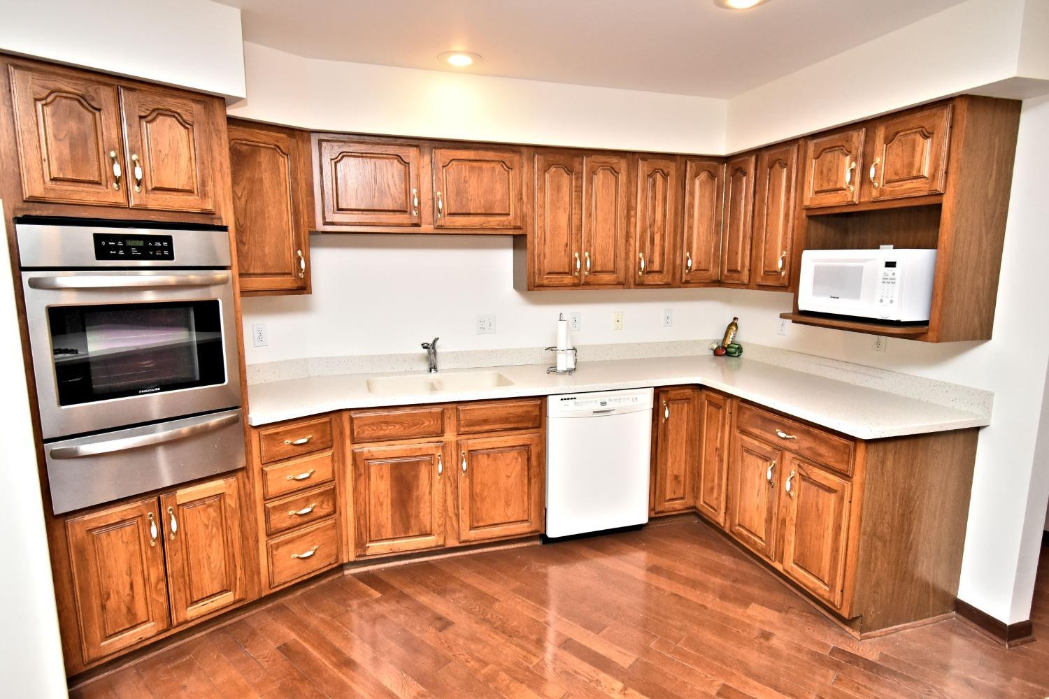 8408 Castle Drive Munster, IN 46321 - Photo 12 of 28 a kitchen with stainless steel appliances granite countertop a sink stove microwave and cabinets