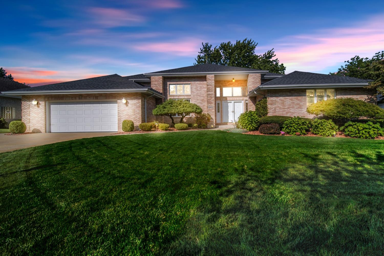 8408 Castle Drive Munster, IN 46321 - Photo 2 of 28 a front view of a house with a yard and garage