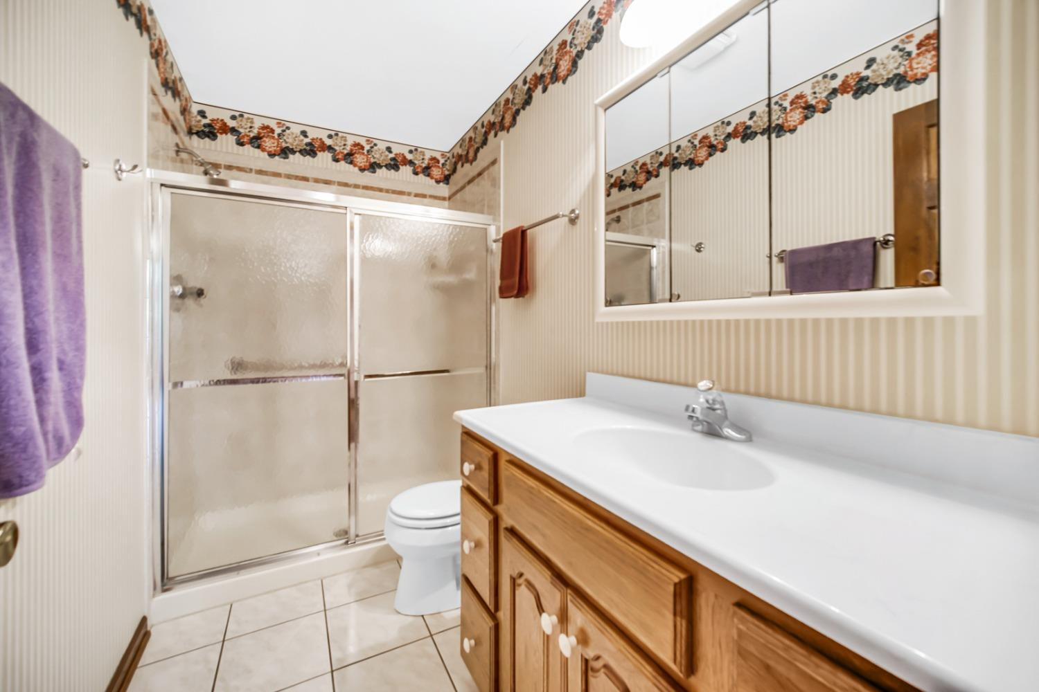 8408 Castle Drive Munster, IN 46321 - Photo 21 of 28 a bathroom with a sink a toilet and shower