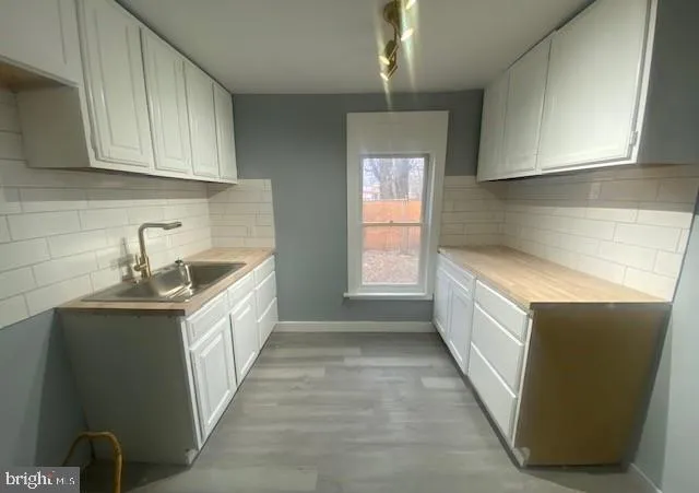 a kitchen with granite countertop a sink and cabinets