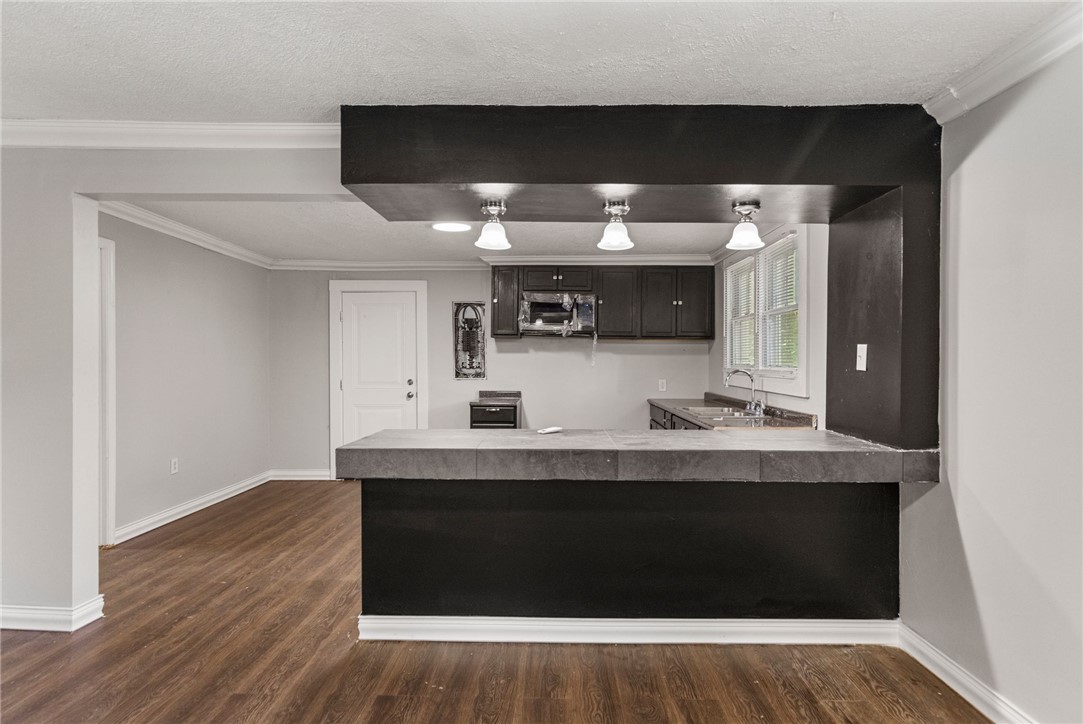 109 Farmer Street Anderson, SC 29621 - Photo 13 of 31 A well-appointed kitchen features a bar and a built-in microwave, ready for culinary endeavors.