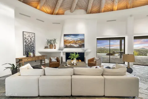 a living room with a couch and a floor to ceiling window
