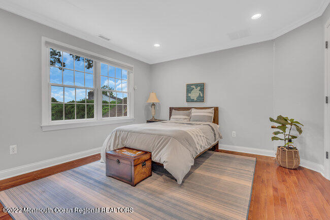 2107 3rd Avenue Spring Lake, NJ 07762 - Photo 20 of 40 a bedroom with a bed and wooden floor