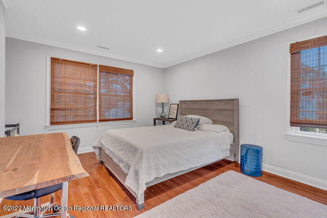 2107 3rd Avenue Spring Lake, NJ 07762 - Photo 27 of 40 a bed sitting in a spacious bedroom next to a window