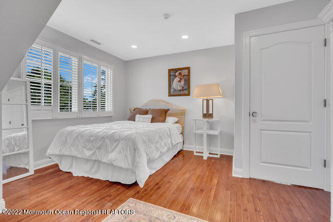 2107 3rd Avenue Spring Lake, NJ 07762 - Photo 32 of 40 a bedroom with a bed and wooden floor