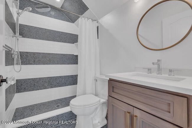 2107 3rd Avenue Spring Lake, NJ 07762 - Photo 33 of 40 a bathroom with a sink a toilet and a mirror