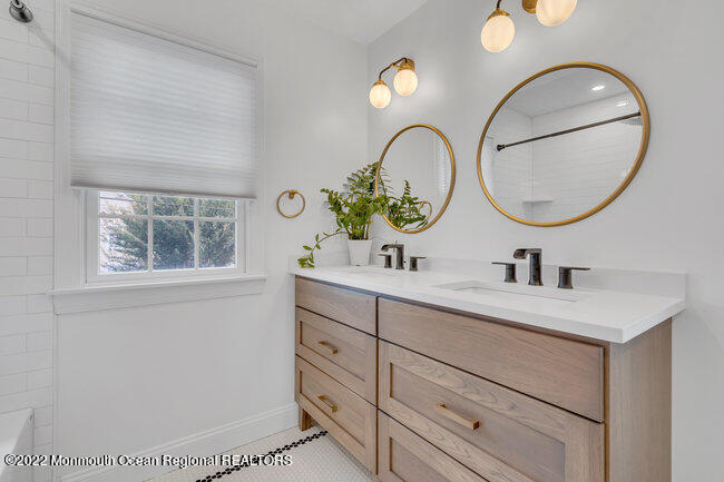 2107 3rd Avenue Spring Lake, NJ 07762 - Photo 37 of 40 a bathroom with a sink a mirror and a window