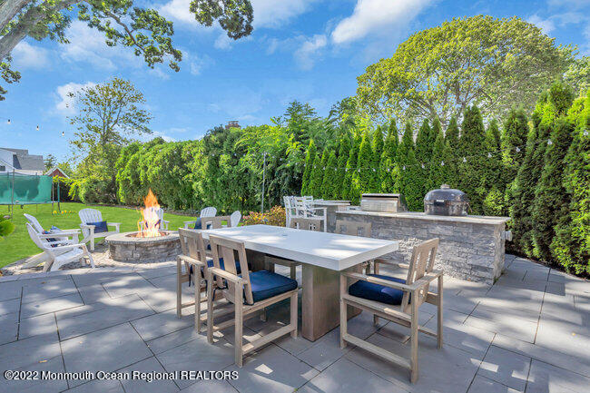 2107 3rd Avenue Spring Lake, NJ 07762 - Photo 38 of 40 a view of a patio with table and chairs and potted plants