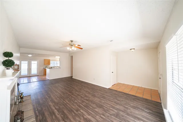 a view of a room with wooden floor