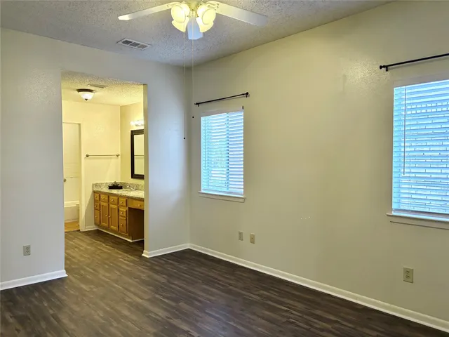 a view of a room with wooden floor and sink