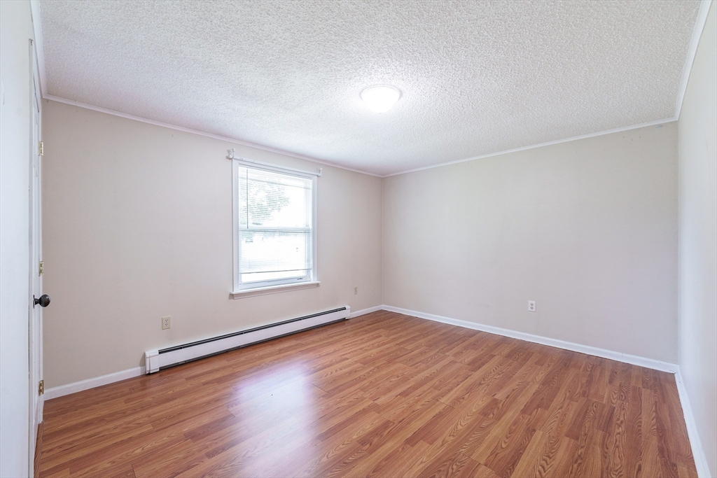 75 Puritan Road Springfield, MA 01119 - Photo 13 of 33 a view of an empty room with wooden floor and a window