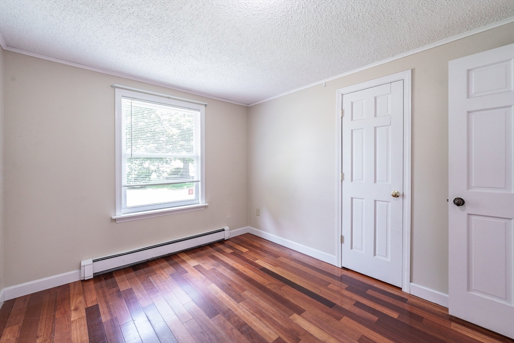 75 Puritan Road Springfield, MA 01119 - Photo 15 of 33 an empty room with wooden floor and windows
