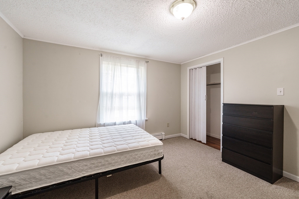 75 Puritan Road Springfield, MA 01119 - Photo 19 of 33 a bedroom with a bed and cabinet
