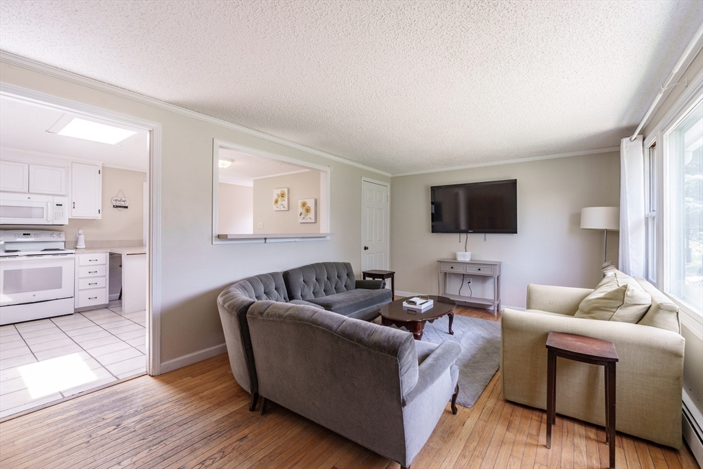 75 Puritan Road Springfield, MA 01119 - Photo 2 of 33 a living room with furniture and a flat screen tv