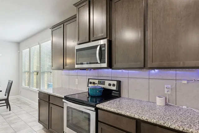 a kitchen with granite countertop stainless steel appliances and sink