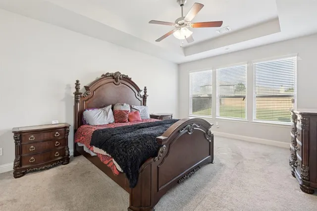 a bed sitting in a bedroom next to a window