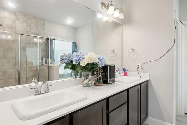 a bathroom with a sink double vanity and a mirror