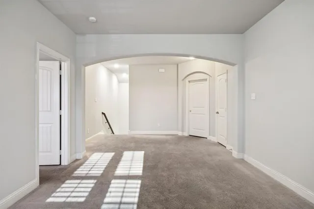 a view of a hallway with a glass door and a window