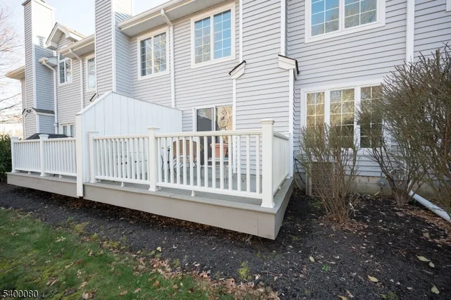 a view of a house with backyard and wooden floor