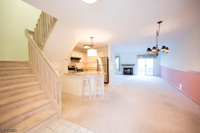 a view of living room with furniture and a fireplace