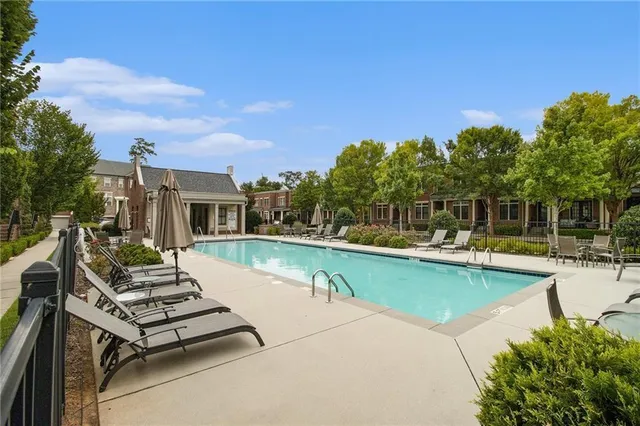 a view of a house with swimming pool and sitting area