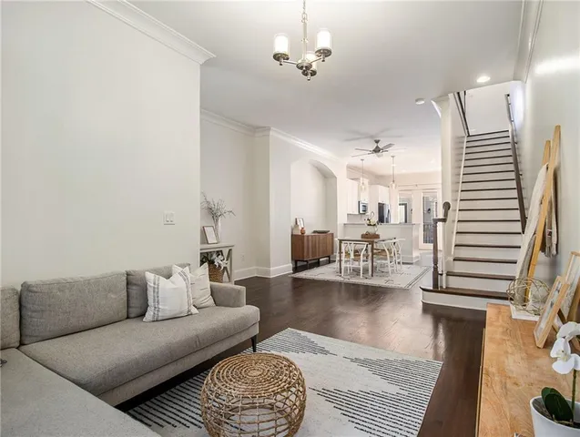 a living room with furniture a rug and a chandelier