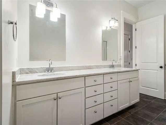 a bathroom with double sink and a mirror