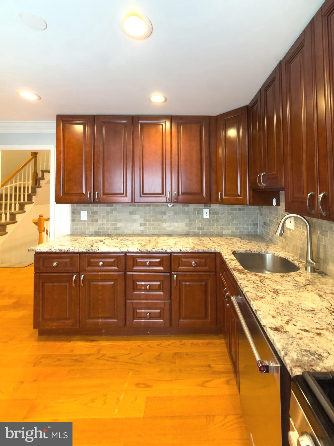 2419 Ansdel Court Reston, VA 20191 - Photo 18 of 41 a kitchen with a sink and a stove top oven