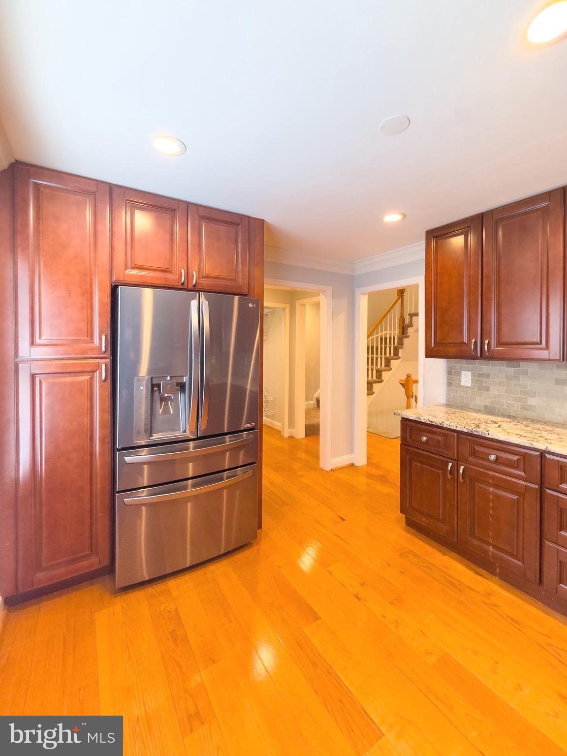 2419 Ansdel Court Reston, VA 20191 - Photo 19 of 41 a kitchen with stainless steel appliances granite countertop a refrigerator sink and cabinets