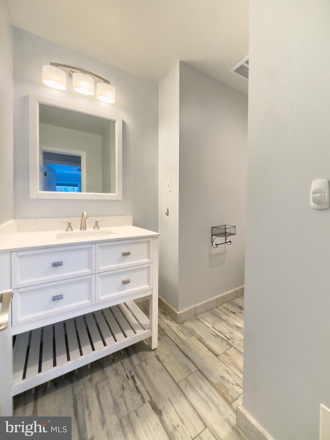 2419 Ansdel Court Reston, VA 20191 - Photo 27 of 41 a bathroom with a sink and a mirror