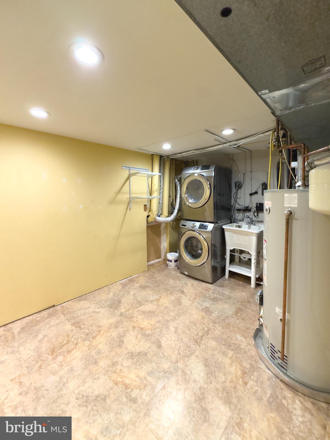 2419 Ansdel Court Reston, VA 20191 - Photo 38 of 41 a view of a storage & utility room with two washing machine