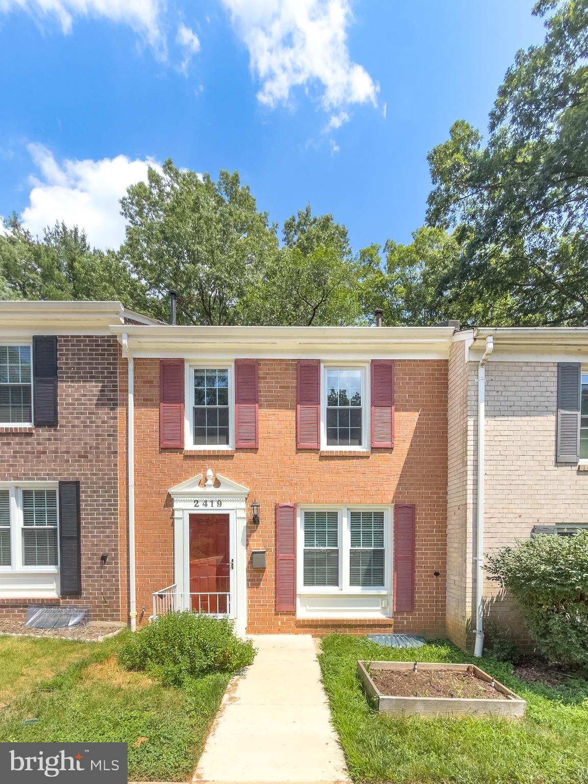 2419 Ansdel Court Reston, VA 20191 - Photo 4 of 41 front view of a house with a yard
