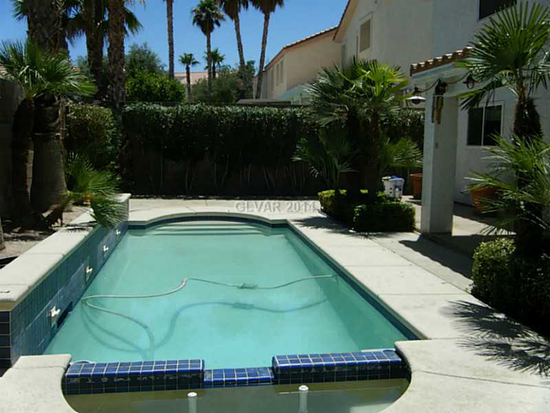 192 Reed Lane Henderson, NV 89074 - Photo 32 of 34 Swimming Pool/Hot Tub/Sauna. View 2 Pool and covered patio with ceiling fans in nicely landscaped back yard