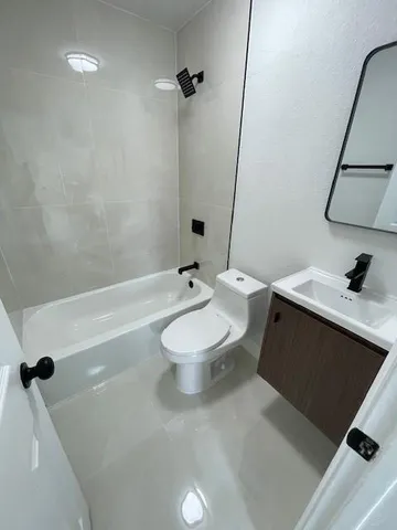 a bathroom with a sink toilet and mirror