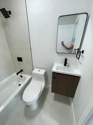 a bathroom with a tub and toilet