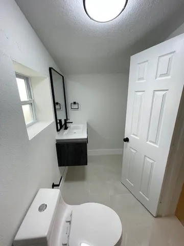 an empty room with a ceiling fan and a window