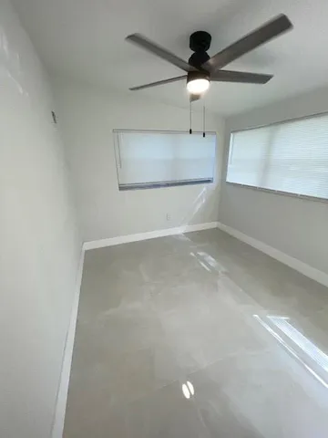 a view of a hallway with a ceiling fan
