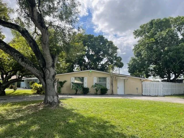 a view of a house with swimming pool and a yard