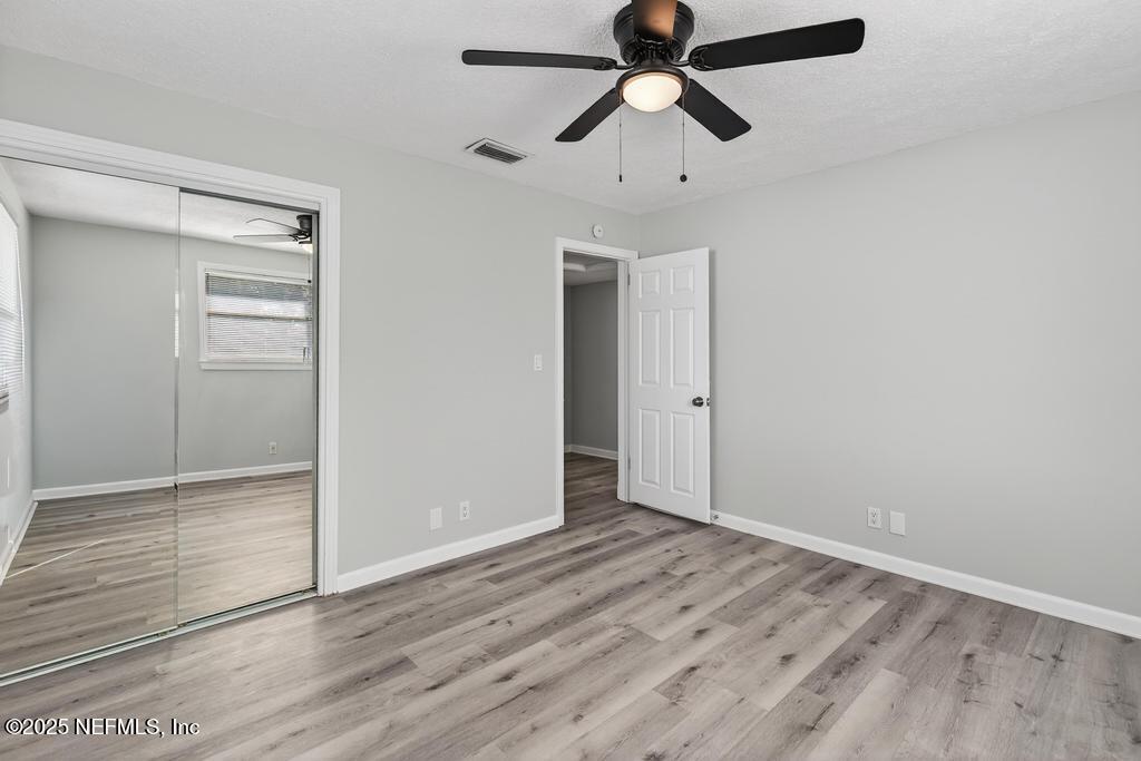 6619 Ector Road Jacksonville, FL 32211 - Photo 54 of 70 an empty room with closet and a ceiling fan