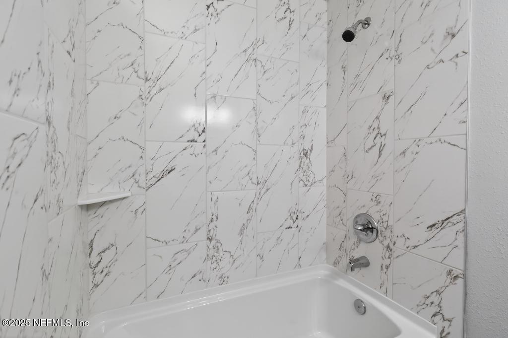 6619 Ector Road Jacksonville, FL 32211 - Photo 60 of 70 a bathroom with a bathtub