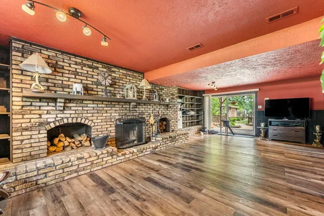 a living room with furniture a flat screen tv and a fireplace