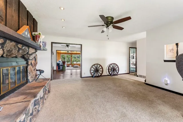 a view of a livingroom with furniture and a ceiling fan