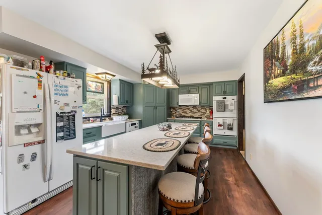 a dining room with furniture a rug and wooden floor