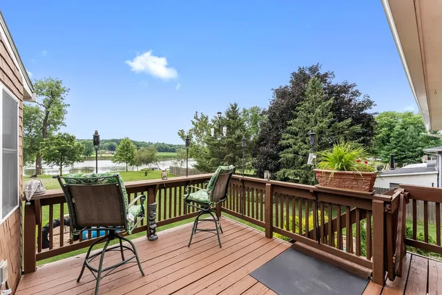 a view of balcony with wooden floor and outdoor seating